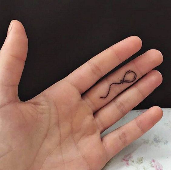 balloon black finger tattoo with string