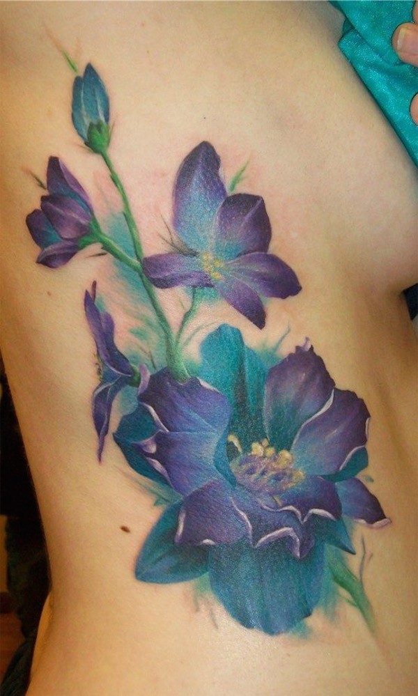 Big blue flower tattoo on side