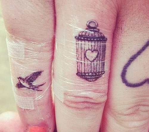 Caged heart with bird tattoo