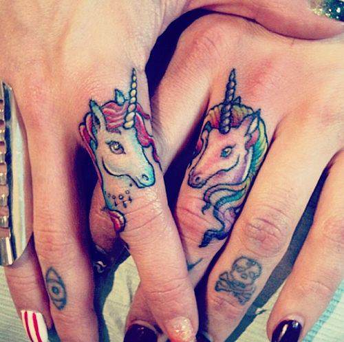 Colored small unicorns on fingers