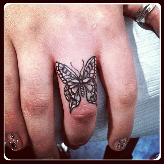 Detailed buttrfly finger tattoo