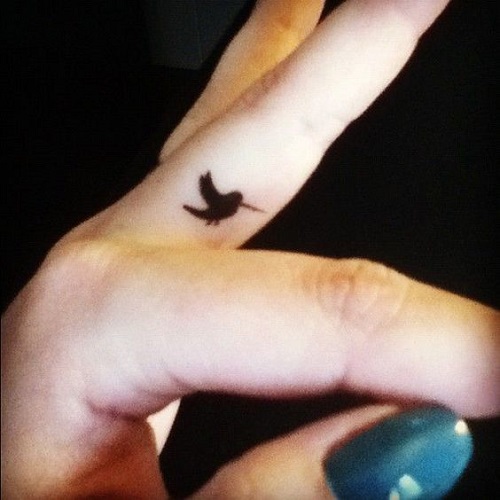 Finger small black bird tattoo