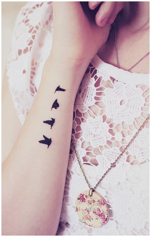 birds flying tattoo arm