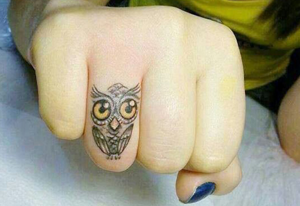 Little finger tattoo of an owl