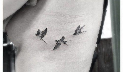 Three birds tattooed on side