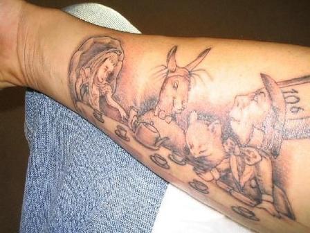 Alice in wonderland cartoon tattoo on arm