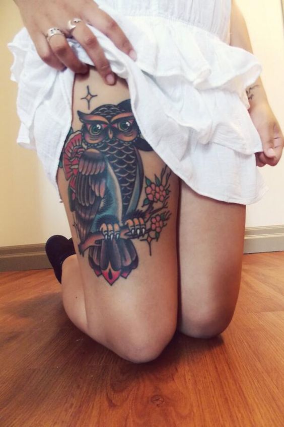 Big colored owl on womens leg