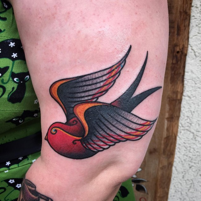 Big colored swallow on thigh