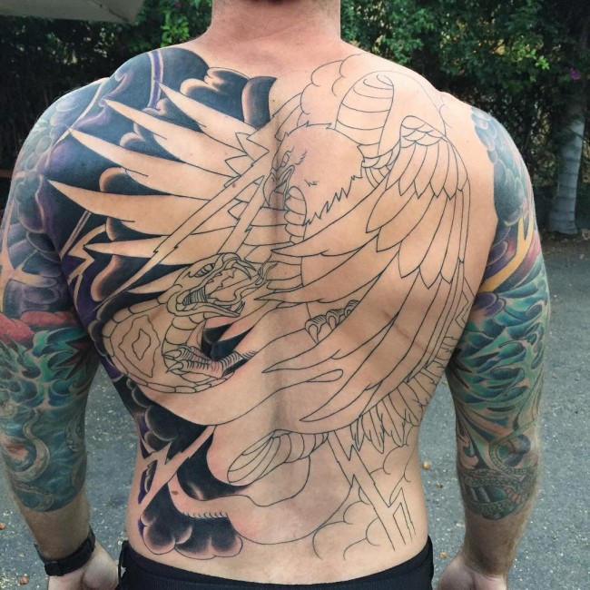 Big uncolored eagle fights with cobra on back