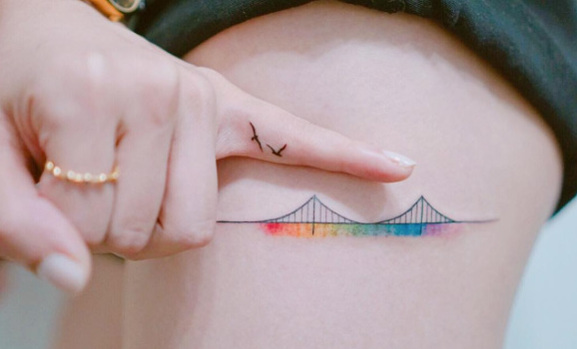 Colorful bridge tattoo with birds