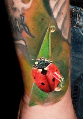 Full colored lady bug on arm