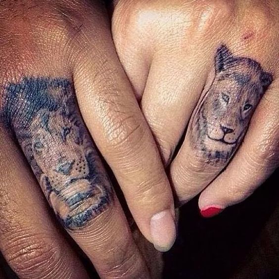 Him her matching lion and lioness finger tattoos