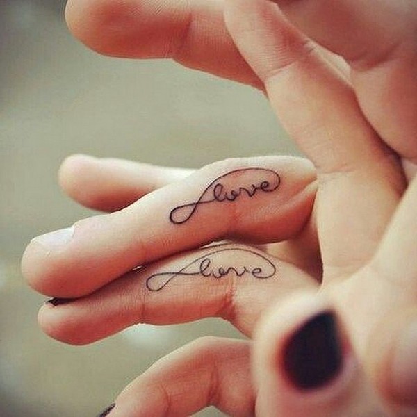 Infinite love matching tattoos on fingers