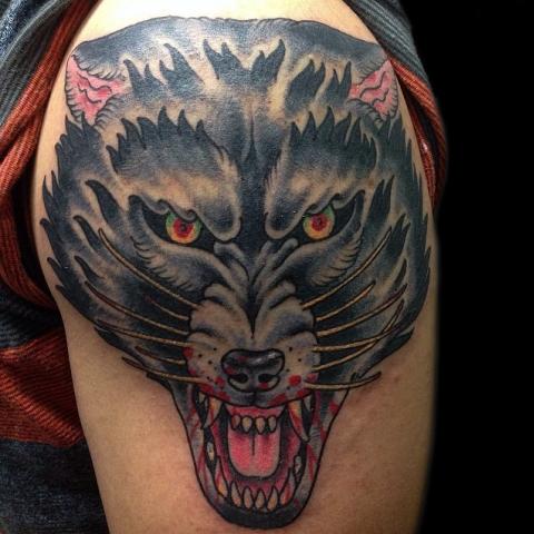 Mad colored wolf drawn on shoulder