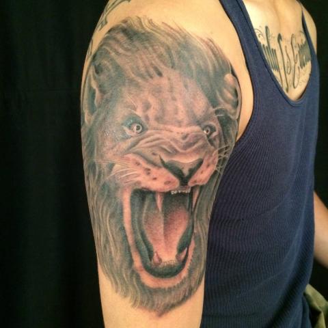 Mad lion in color on shoulder