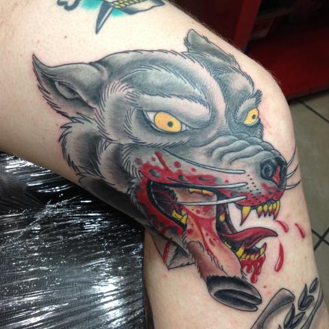 Mad wolf drawing in color on knee
