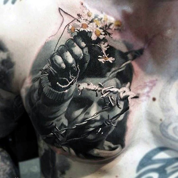 Male torso realistic tattoo of boy holding colored blooms