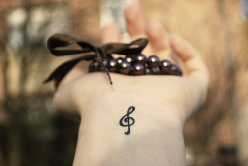 Musics symbol in minimal tattoo