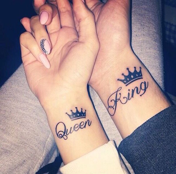 Queen and king crowns on wrist