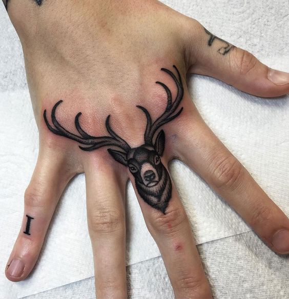 Rain deer middle finger tattoo