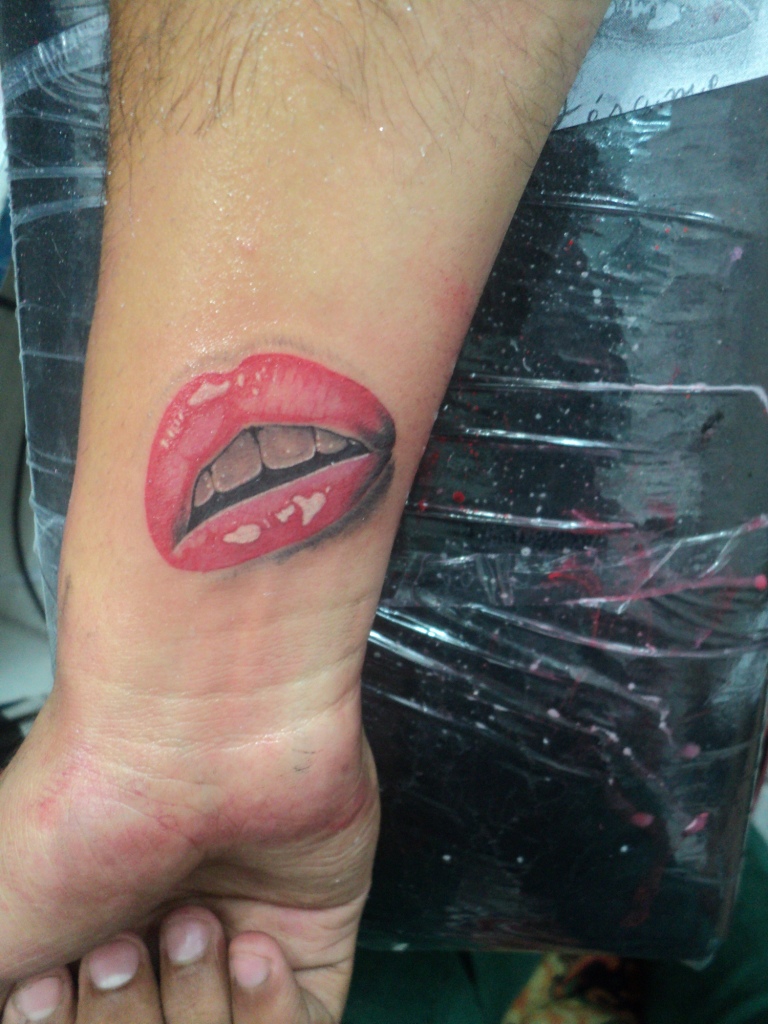 Right forearm realistic lips tattoo