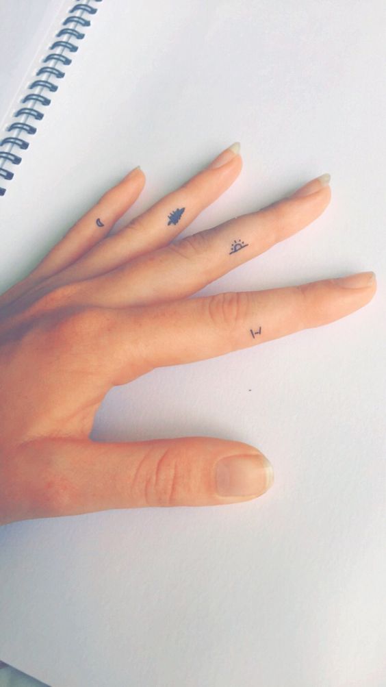 Small finger tattoos on each finger