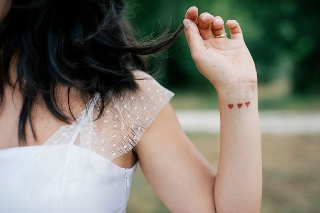 Three red hearts on arm