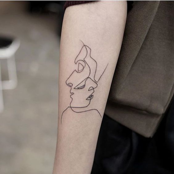 Two faces minimal tattoo