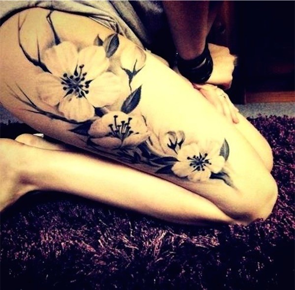 Yellow and grey thigh flower tattoos